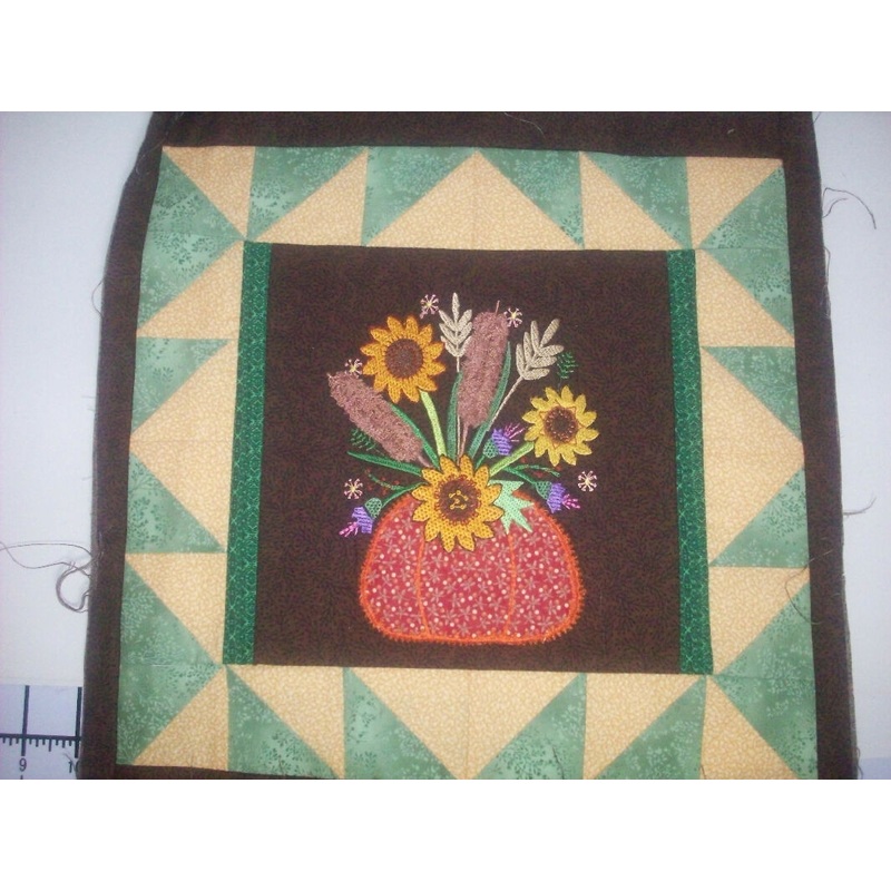 Potted Flowers machine embroidered on center block in 14 inch quilt block - My wife's work
