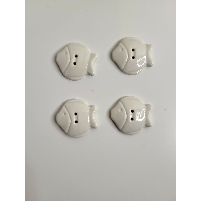 White plastic fish buttons, set of 4.